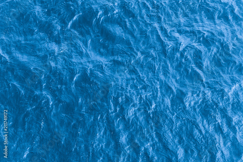 Beautiful sea background - blue water surface with small ripples, top view photo