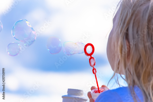 Girl having fun blowing soap bubbles. Photo from Sotkamo, Finland. photo