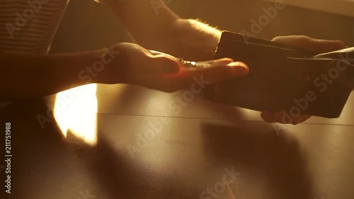 A man with indignation throwing an empty purse on the table