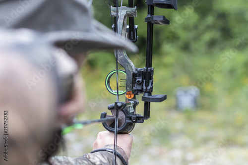 A Man Shooting a Compound Bow  photo