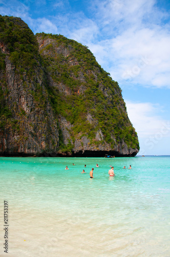 Tourists swimming in turquoise Andaman sea and white beach Phi Phi island and Krabi - Phuket, Thailand