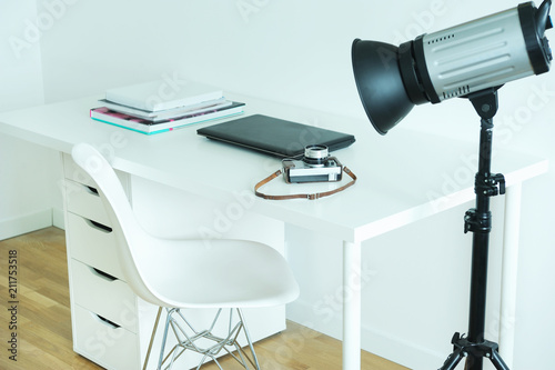 Photographer's workplace with laptop and camera.The workplace of the photographer in the Scandinavian style.