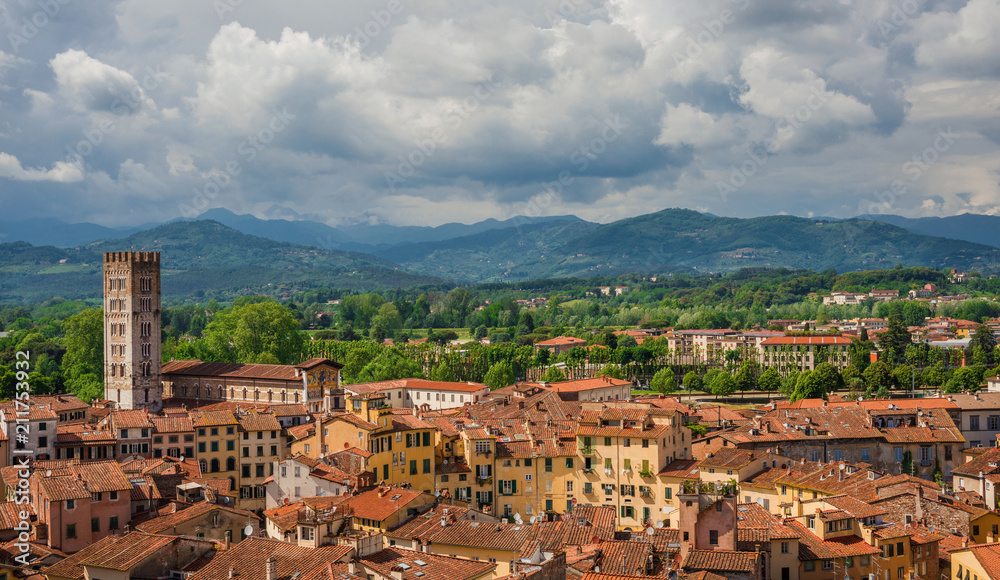 Panorama of Lucca medieval center with the famous Piazza dell'Anfiteatro (Amphitheatre Square), the romanesque Basilica of San Frediano (St Fridianus)  and the Apennines mountains