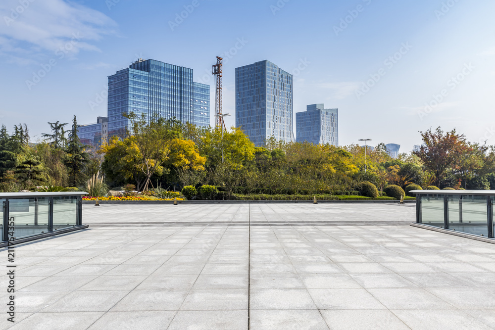 Modern business office buildings with empty road,empty concrete square floor Modern business office buildings with empty road,empty concrete square floor