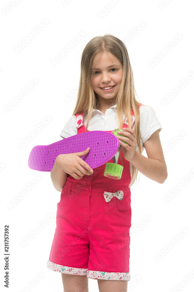 Modern hobby. Penny boards also known as mini cruiser. Girl smiling face holds penny board isolated white background. Originally designed as girls skateboard. Kid girl ready ride penny board Modern hobby. Penny boards also known as mini cruiser. Girl smiling face holds penny board isolated white background. Originally designed as girls skateboard. Kid girl ready ride penny board