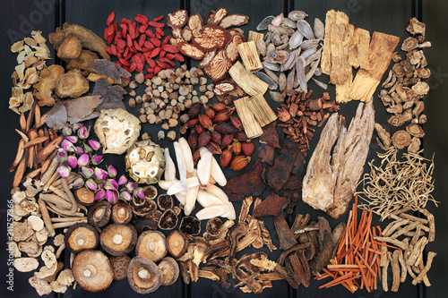 Fotografie Traditional chinese herbs used in alternative herbal medicine on dark wood background