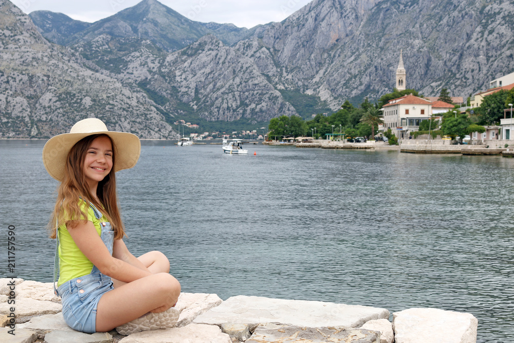 happy teenage girl enjoys a summer holiday Kotor bay Montenegro
