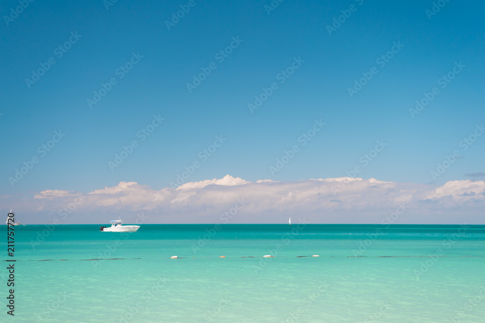 Travel agency. Sky with clouds over calm tropical sea. Boat touristic ship in turquoise ocean lagoon. Travel ship touristic boat tranquil lagoon. Sea ship excursion for holidaymakers