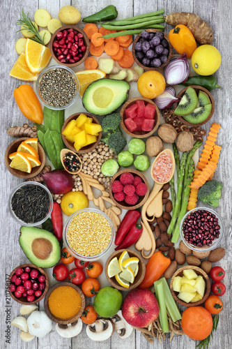 Fototapeta Naklejka Na Ścianę i Meble -  Health food concept with fruit, vegetables, herbs, spice, nuts, seeds, grain and pulses. Super foods high in antioxidants, anthocyanins, smart carbohydrates, fibre, vitamins and minerals.