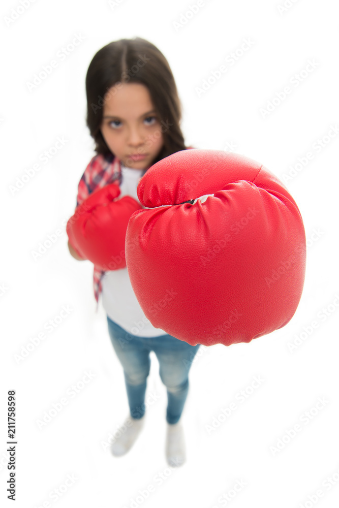 Feministic upbringing. Every girl should know how defend herself. Girl seriously training boxing gloves. Child concentrated face with sport gloves practice fighting skills isolated white. Girls power Feministic upbringing. Every girl should know how defend herself. Girl seriously training boxing gloves. Child concentrated face with sport gloves practice fighting skills isolated white. Girls power