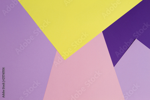 Color papers geometry flat composition background with violet, purple, pink, red, yellow tones.