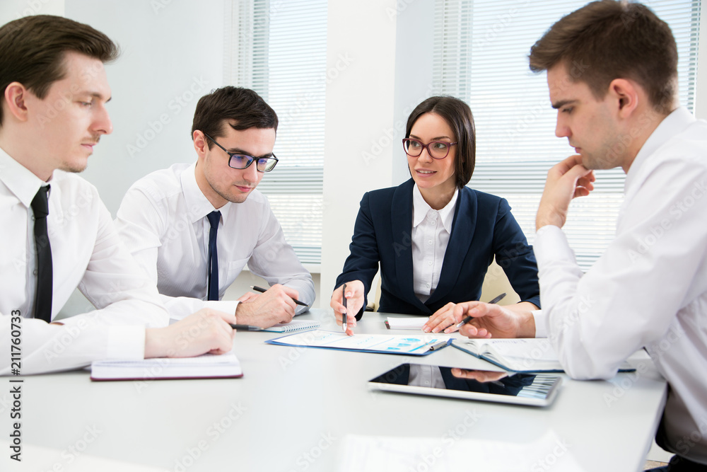 Business people are sitting around the table at a meeting in the office Business people are sitting around the table at a meeting in the office