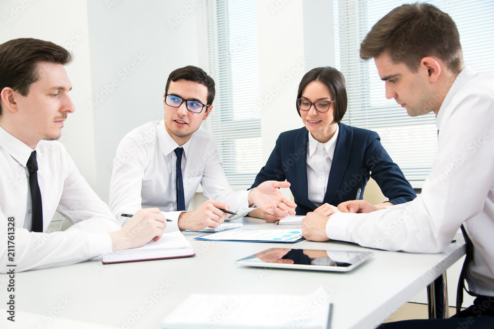 Business people are sitting around the table at a meeting in the office Business people are sitting around the table at a meeting in the office