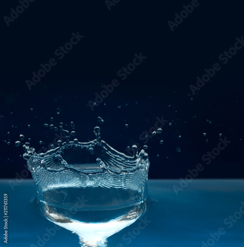 Beautiful splash of blue water isolated on dark background