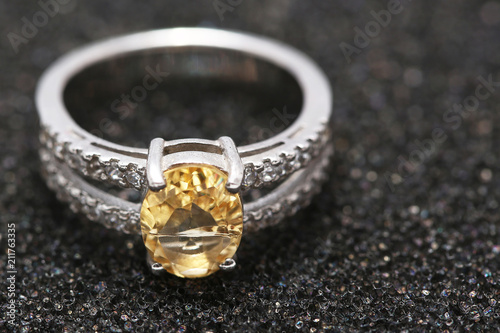 Yellow gem stone on diamond ring