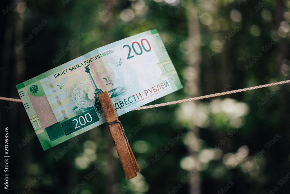 Russian Banknote Two hundred rubles hanging on the clothespin