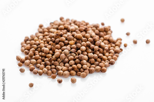 fragrant coriander seeds on a white background