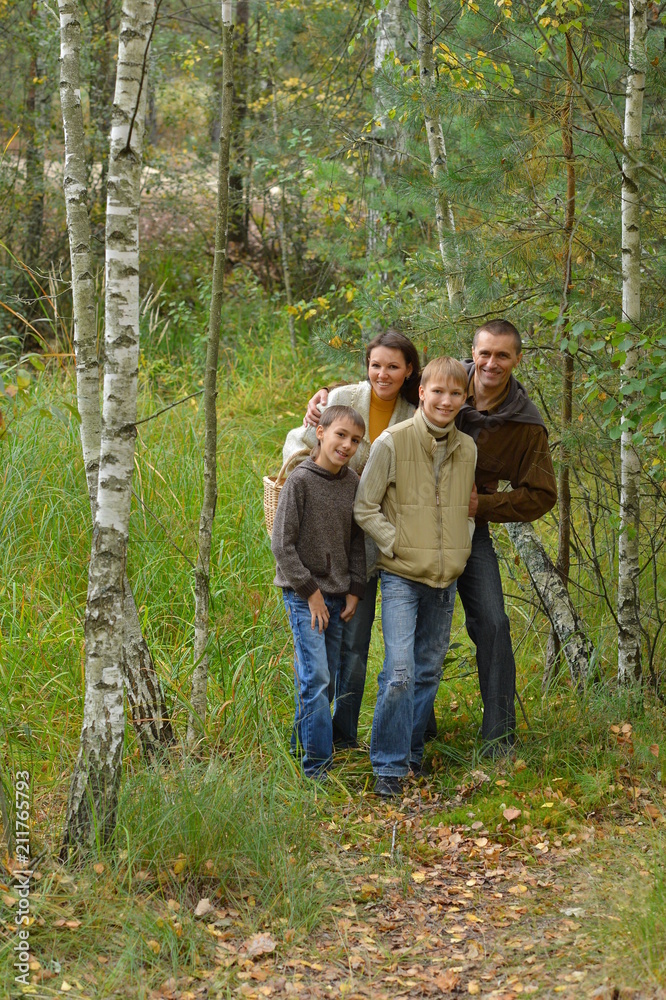 Happy smiling family in autumn forest posing Happy smiling family in autumn forest posing
