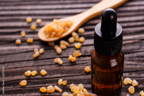 frankincense essential oil on a wooden background