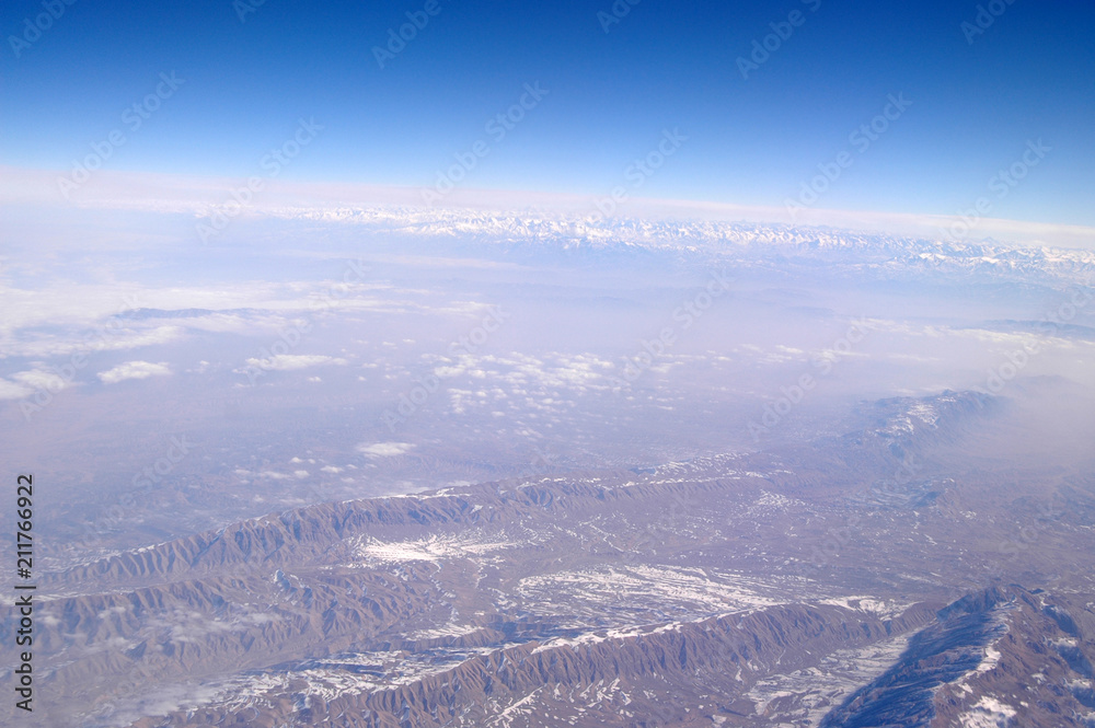 Earth surface on blue sky, aerial view. Environment protection and ecology. Mountain landscape. Wanderlust and travel. Heaven on earth