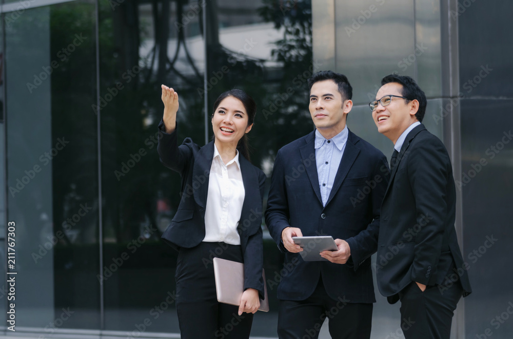 group of business people in suit talking and reading information about finance news in laptop computer together standing in modern city, network technology, internet, successful, teamwork concept group of business people in suit talking and reading information about finance news in laptop computer together standing in modern city, network technology, internet, successful, teamwork concept