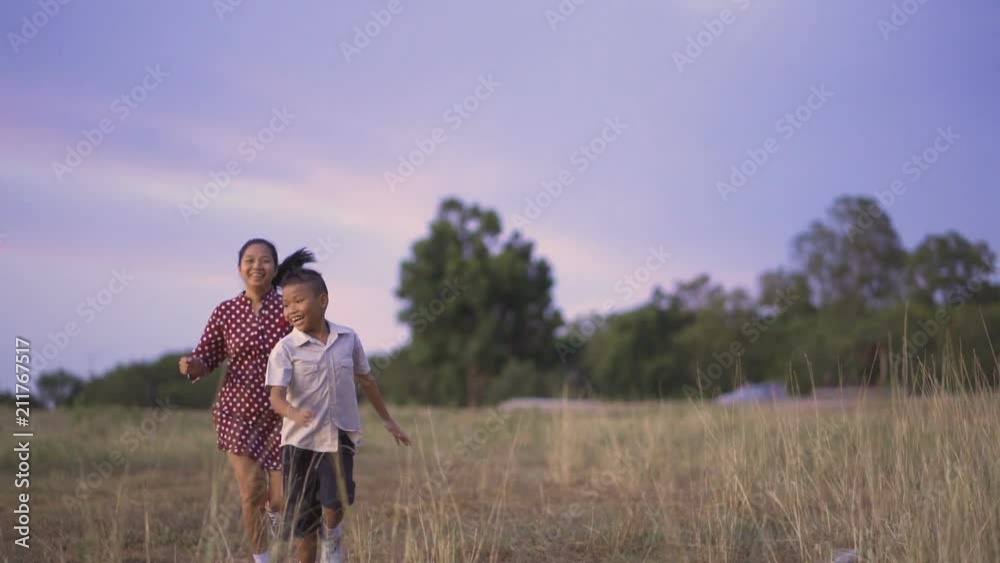 Asian families, Mothers sons and daughters are running happily on holiday grounds. Asian families, Mothers sons and daughters are running happily on holiday grounds.