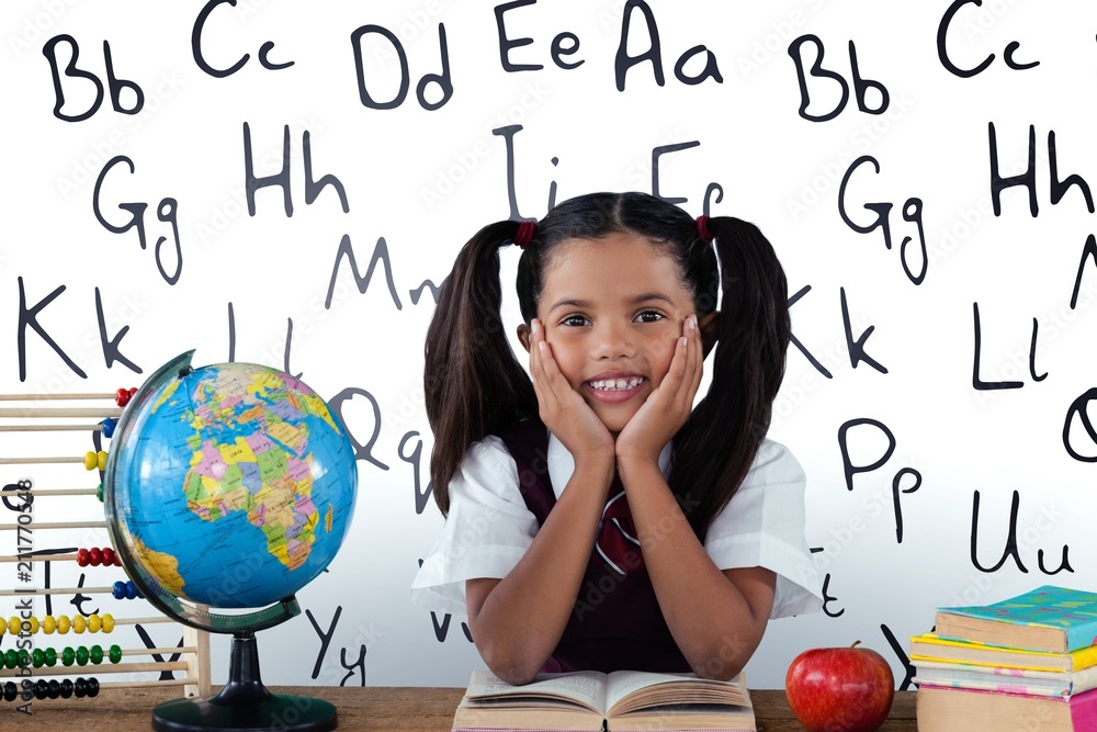 Fototapeta premium Composite image of schoolgirl leaning by globe and books