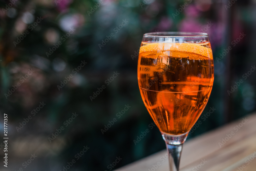 Aperol spritz cocktail in glass on wooden table on dark background in cafe Aperol spritz cocktail in glass on wooden table on dark background in cafe