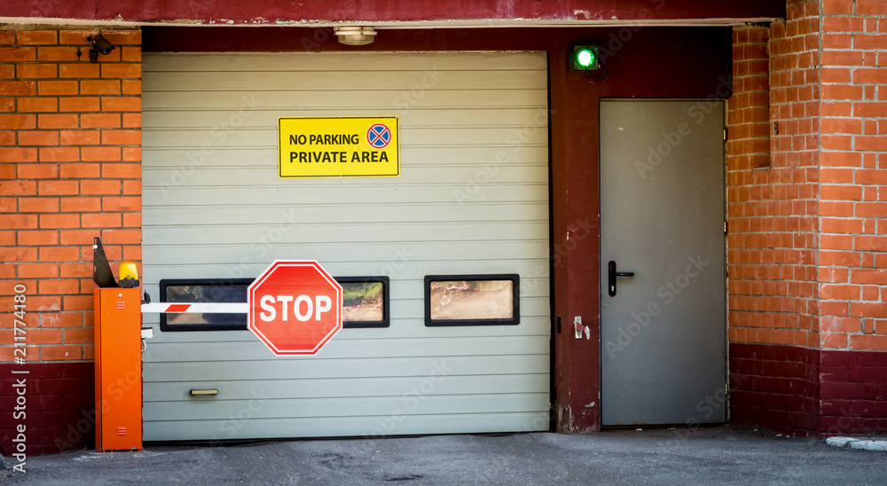 Fototapeta premium Entry to an underground car park with automatic gates and a barrier.
