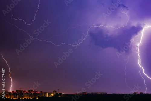 Thunderstorms vivid blue sky and lightnings above night city