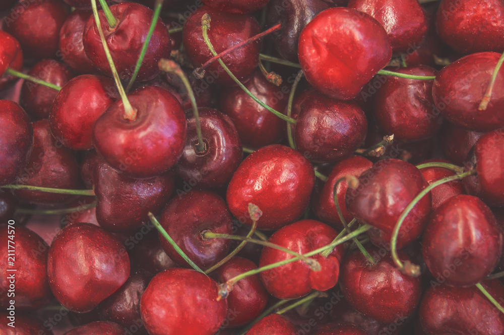 Berries background texture of juicy red cherry and cherries berry on market closeup Berries background texture of juicy red cherry and cherries berry on market closeup
