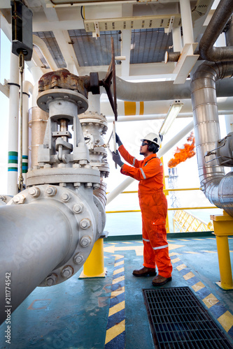 Offshore oil and gas operations, production operator open manual operated valve for control gas flow rate in process gas platform