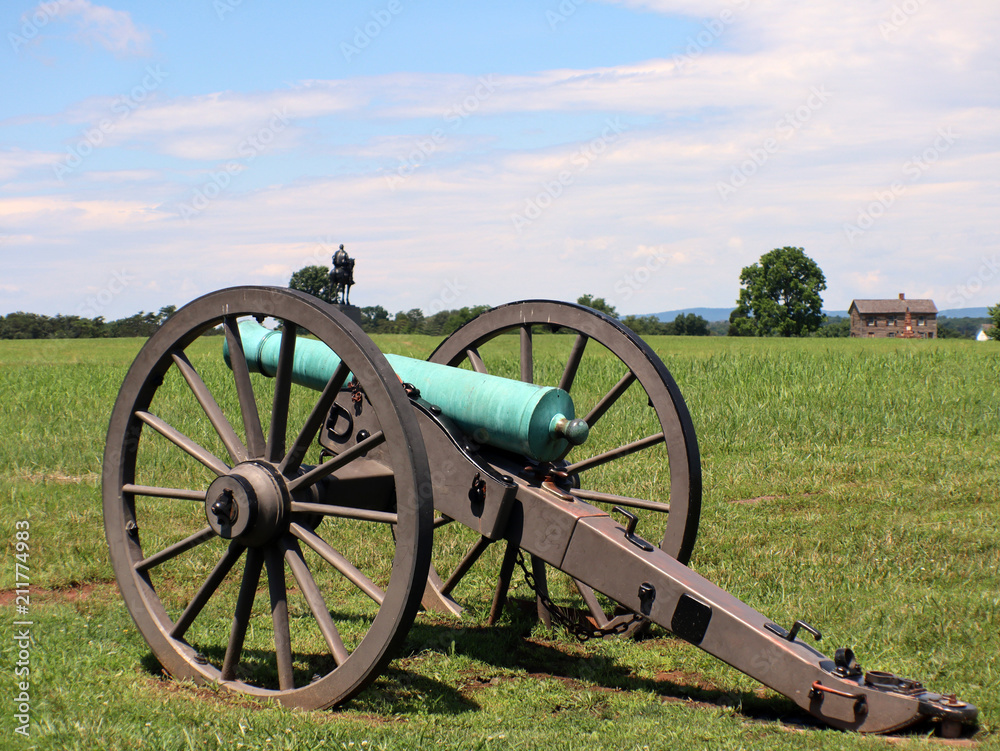 Civil war cannon with house and moument