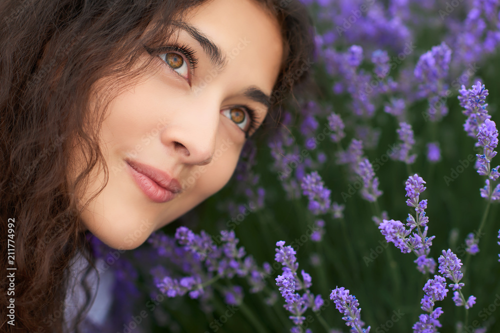 young woman is in the lavender field, beautiful portrait, face closeup, summer landscape with red poppy flowers young woman is in the lavender field, beautiful portrait, face closeup, summer landscape with red poppy flowers