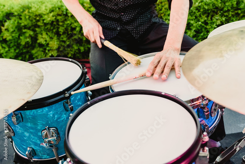set of drums being played by drummer