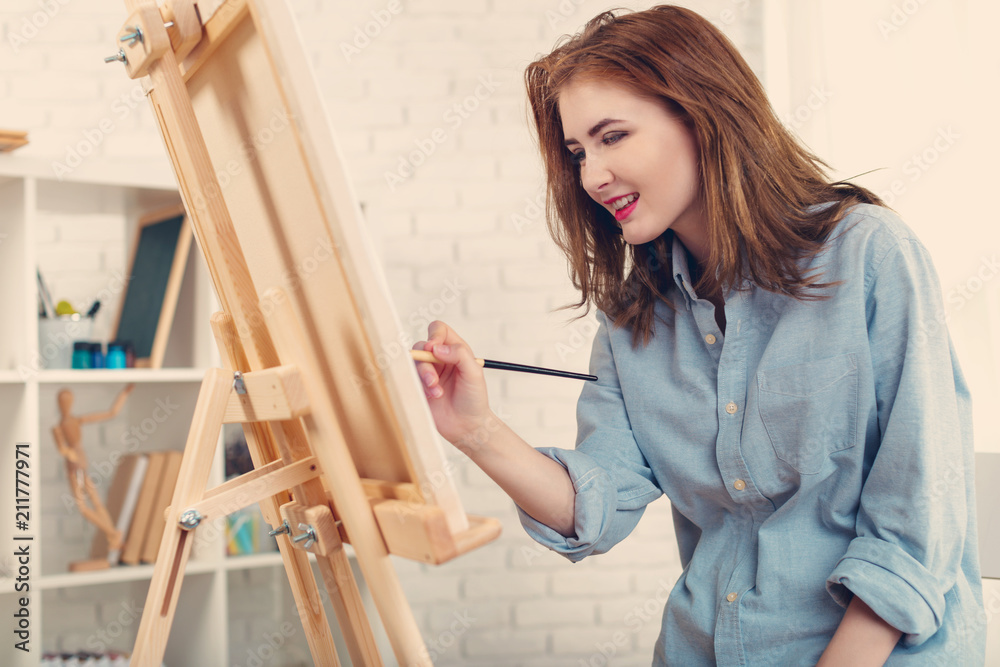 Beautiful young woman painter at work Beautiful young woman painter at work