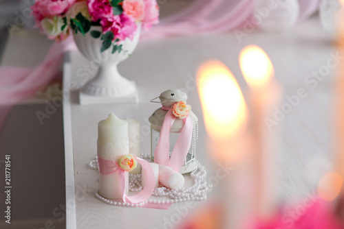 Beautiful decor of candles and flowers. White Pink shades. photo
