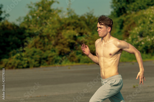 Young adult male jogging shirtless © Ben Gingell