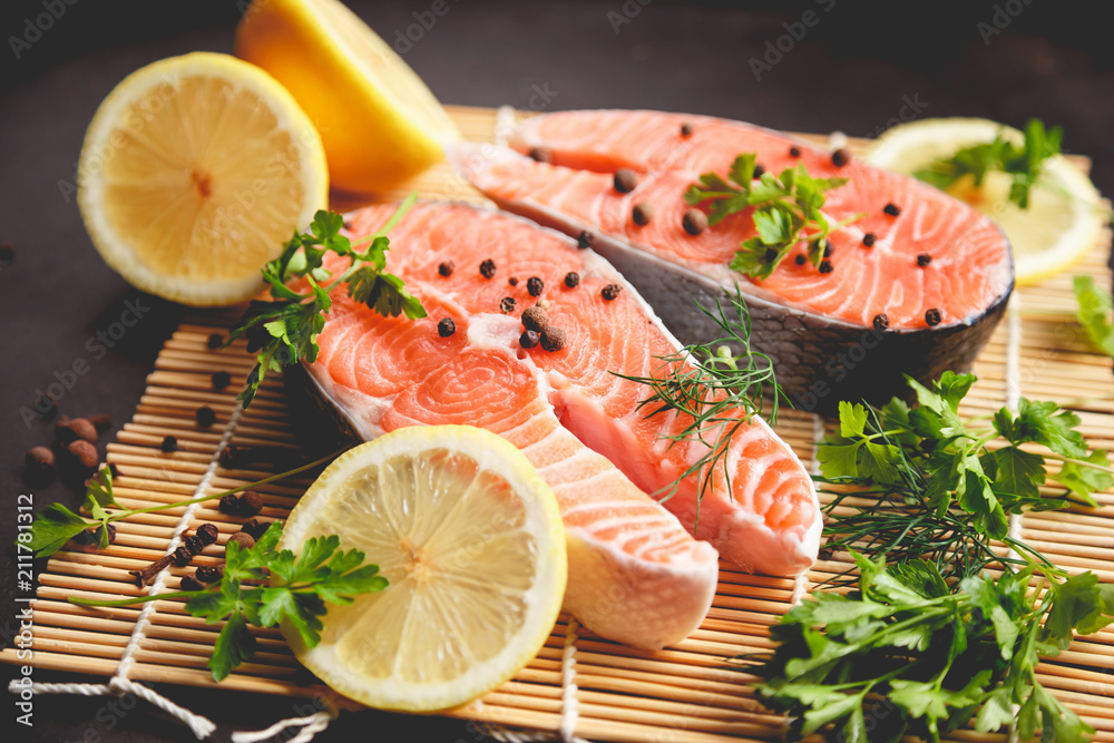Salmon steaks with lemon and spices close up view. Salmon steaks with lemon and spices close up view.