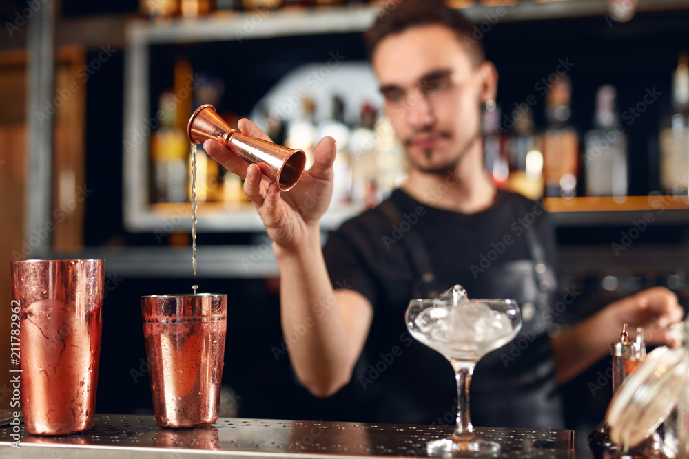 Cocktail. Bartender Making Cocktails in Bar