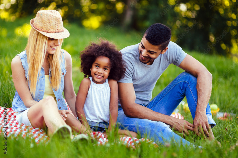 Picture of lovely couple with their daughter having picnic Picture of lovely couple with their daughter having picnic