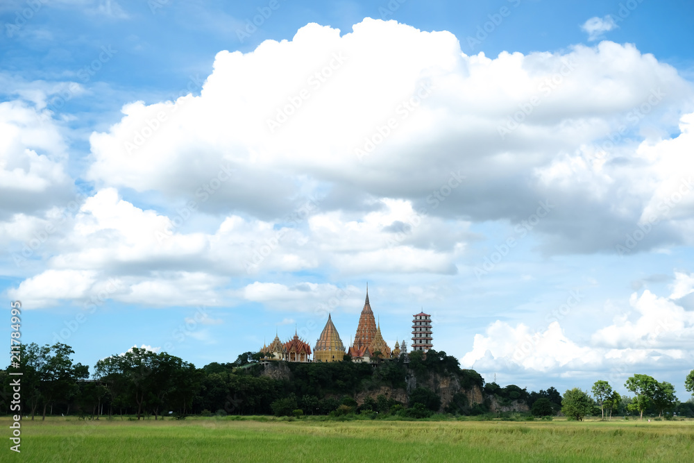 View  Wat Thum Sua and paddy field on blue sky in Thailand