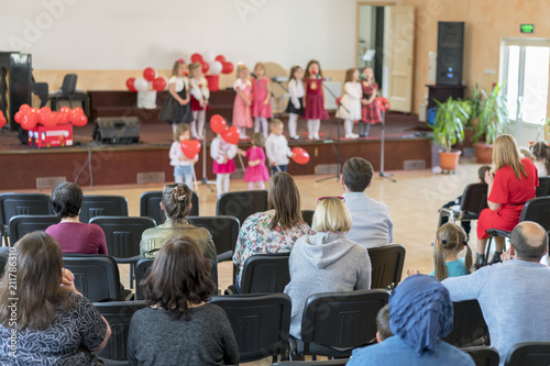 A children's holiday in the kindergarten. Speech of children in the kindergarten in the hall on the stage. parents are watching the performance children in kindergarten