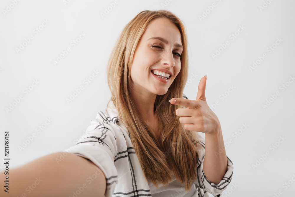 Happy young casual girl taking selfie Happy young casual girl taking selfie