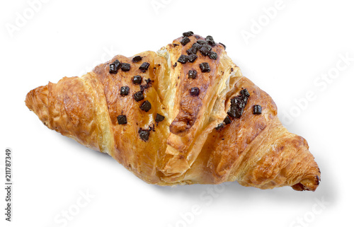 Delicious french chocolate croissant or butter croissant with chocolate filling and  chocolate crumbles. Fresh croissant, top view, isolated on white background.