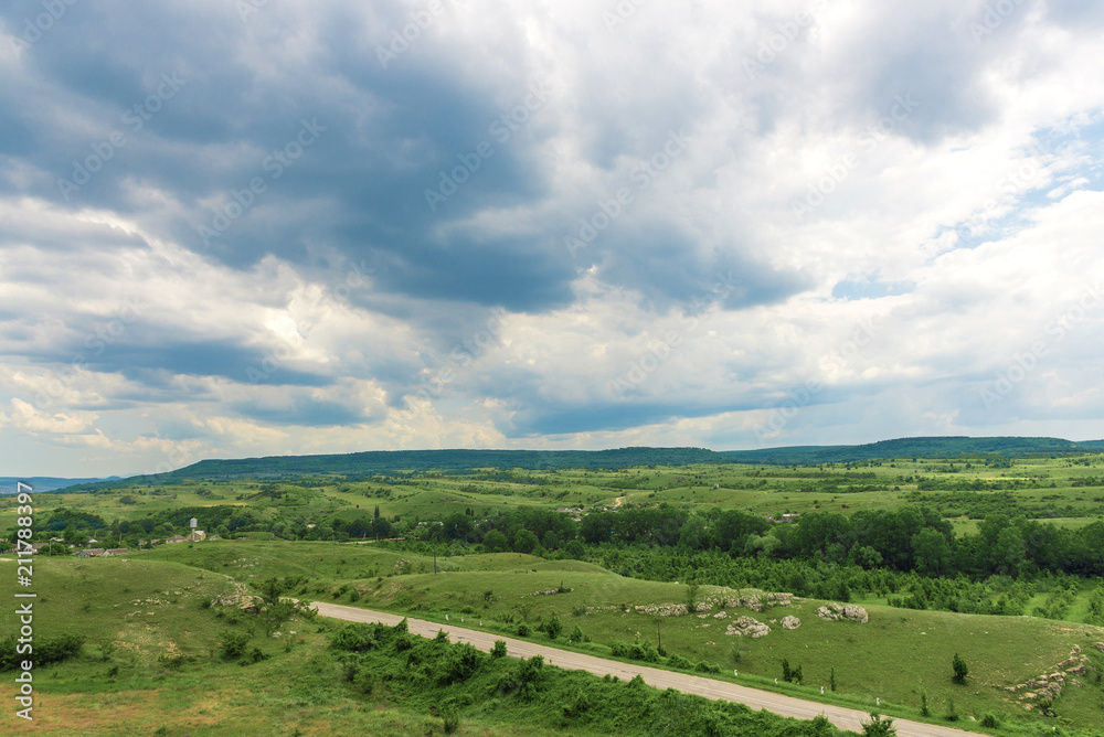 Fototapeta premium Road between green hills and