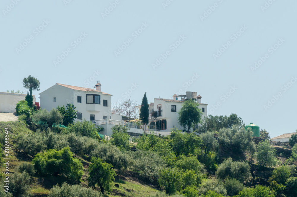 typical spanish village houses and farmland in the hills of andalusia