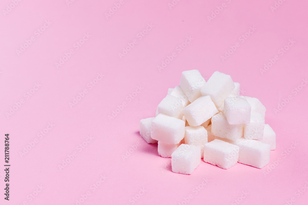 Sugar cubes bunch on pink background Sugar cubes bunch on pink background