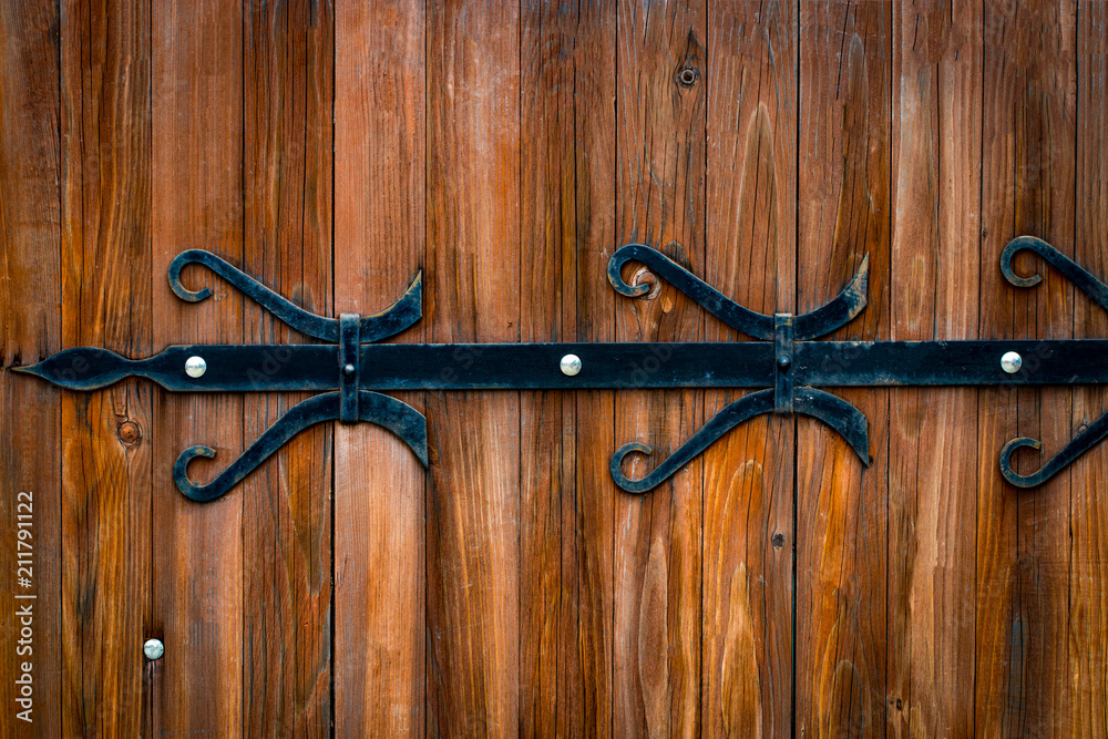 wooden gate with wrought iron elements close up wooden gate with wrought iron elements close up
