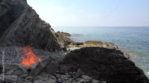 Bonfire in the rocks on the seacoast. photo